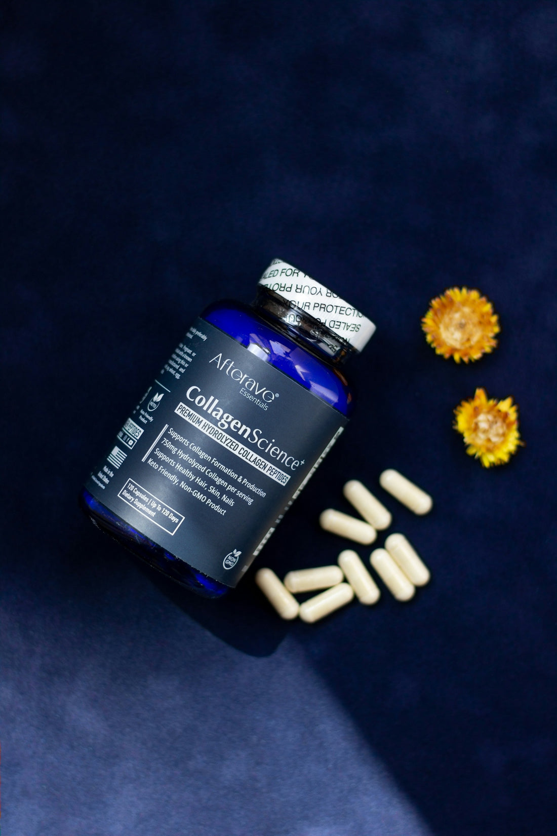A close up of a bottle of pills next to flowers