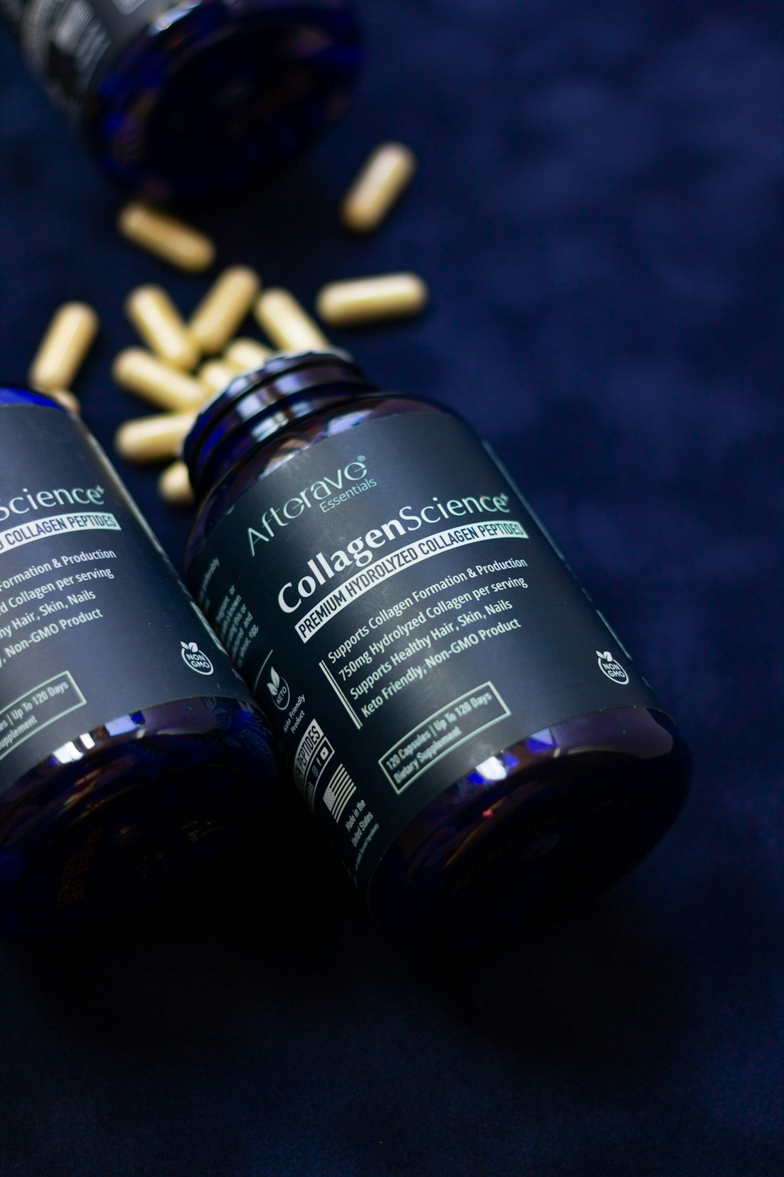 Two bottles of vitamins sitting on a blue surface