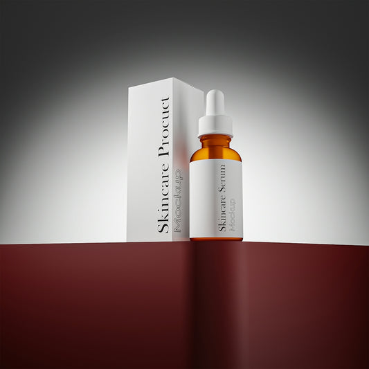 Skincare serum bottle and box on a red surface.